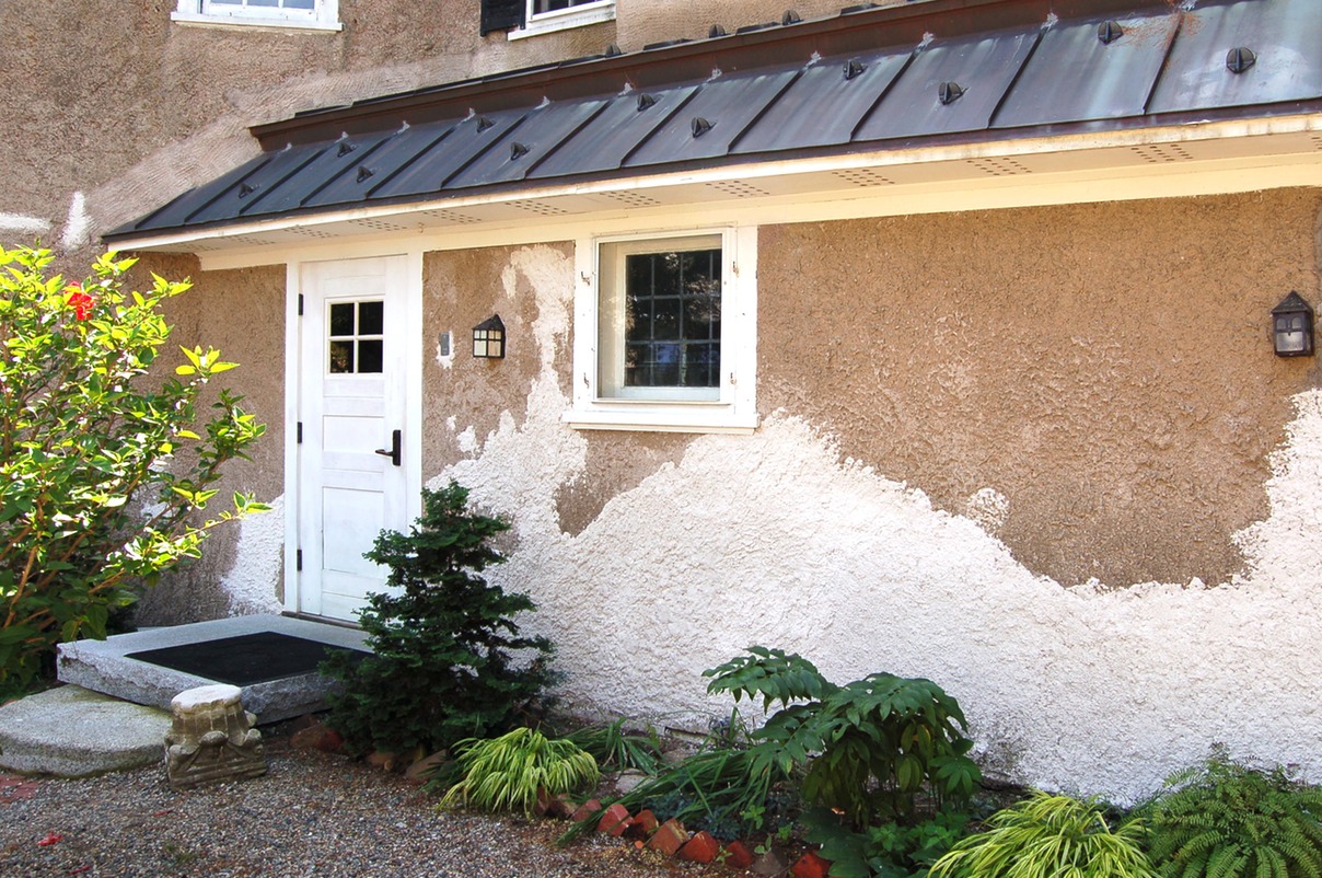  Portland cement mortar removed and lime stucco restored with a Harling finish to match the original stucco