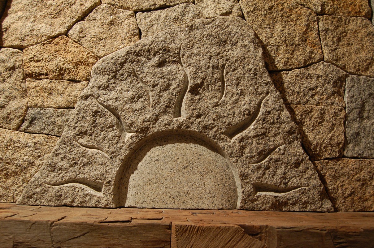 Carved granite piece over mantle
