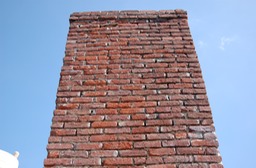 Previous Portland cement mortar repairs on brick chimney removed
